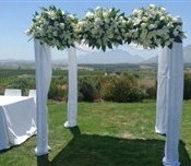 Bridal canopy with white roses and lilies garden wedding